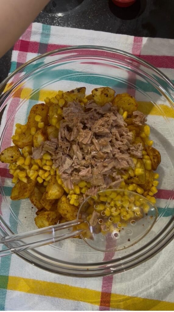 Drained canned tuna added to potatoes and corn