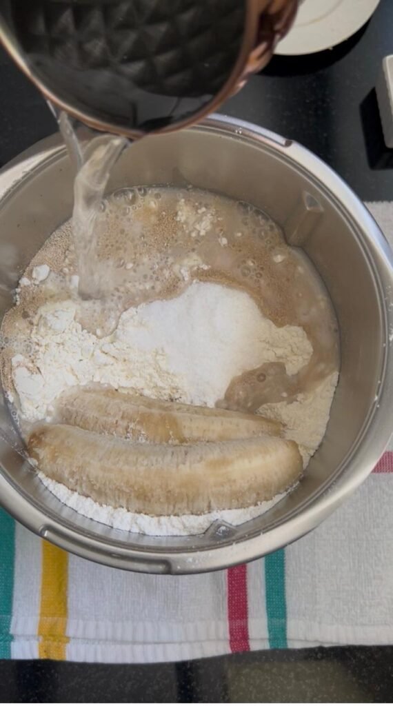 Warm water poured into the banana dinner roll dough