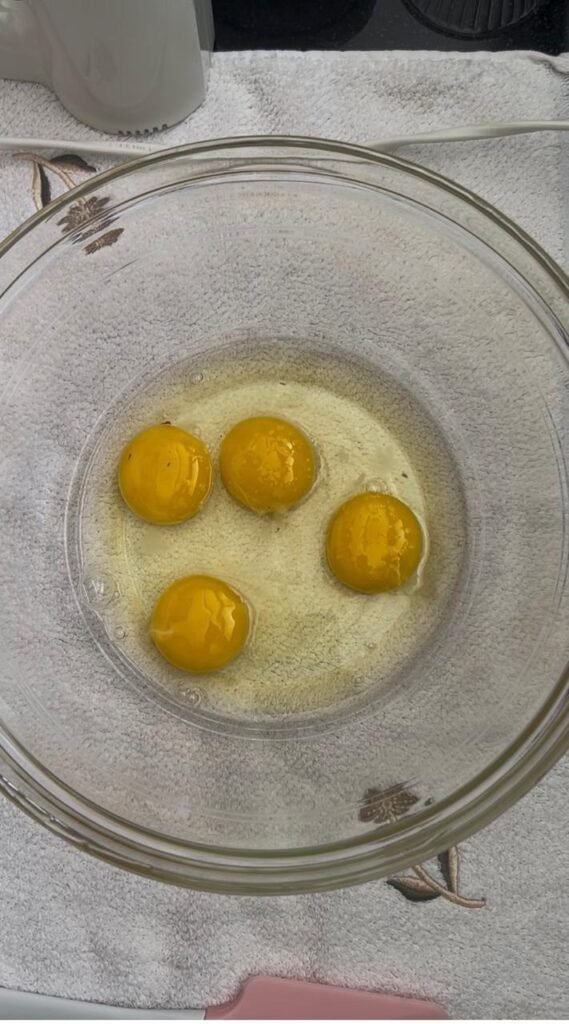 Cracking eggs to start the almond cake batter