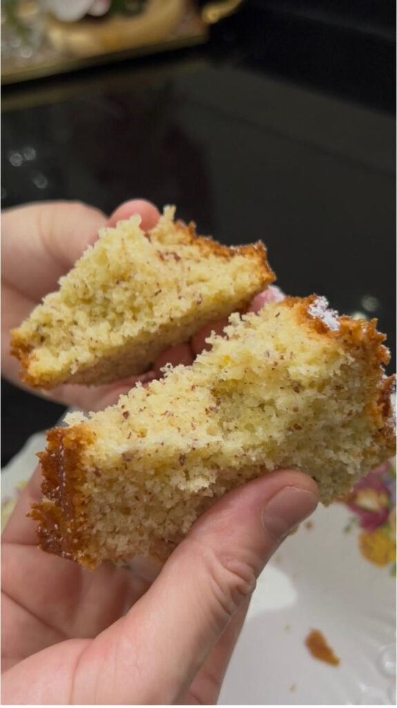 Slice of fluffy almond cake showing the light tender crumb