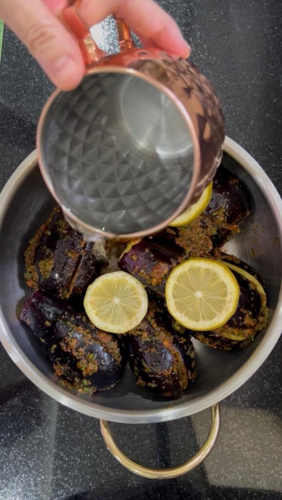Chermoula stuffed eggplant arranged in a pot with lemon slices
