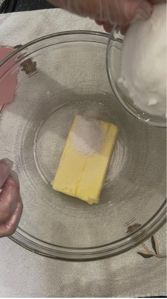 Softened butter and sugar in a glass bowl before mixing cookie dough