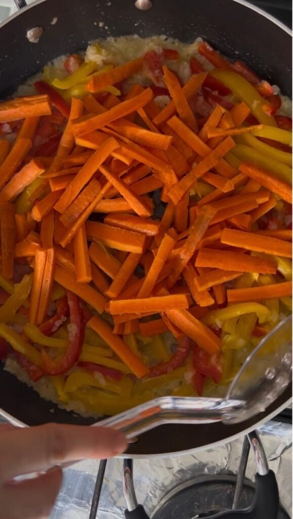 Julienned carrots added to the stir fry vegetables