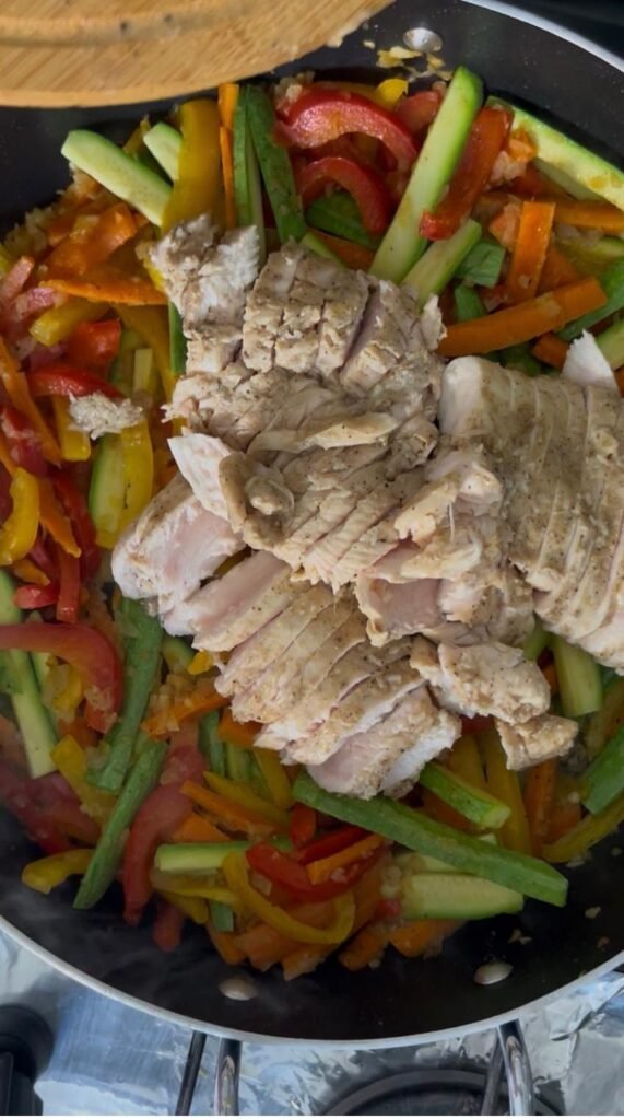 Seared chicken returned to the pan with the vegetables