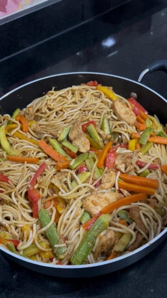 Finished chicken stir fry noodles in a large skillet