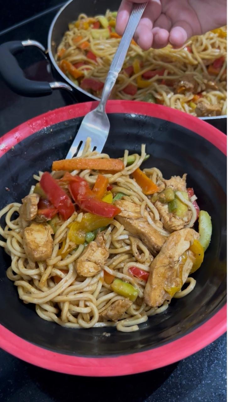 Chicken stir fry noodles recipe served in a bowl with peppers and carrots