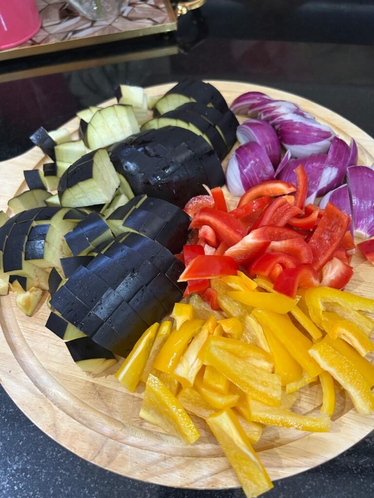 Cubed eggplant, sliced peppers and onion ready for the air fryer