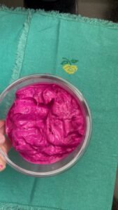 Creamy pink dragon fruit ice cream in a glass bowl