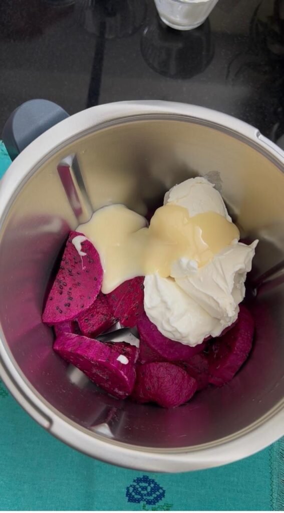 Frozen dragon fruit, yogurt, cream cheese and condensed milk in a blender