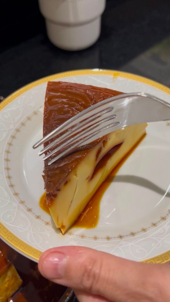 Forkful of creamy Venezuelan flan on a plate