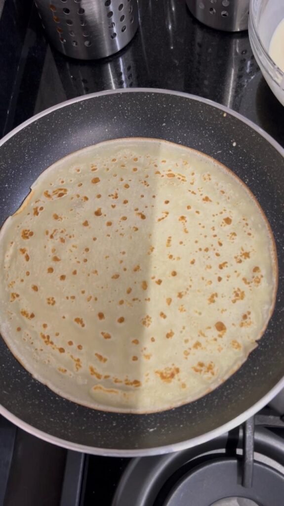 Golden buttermilk crepe cooked in a skillet