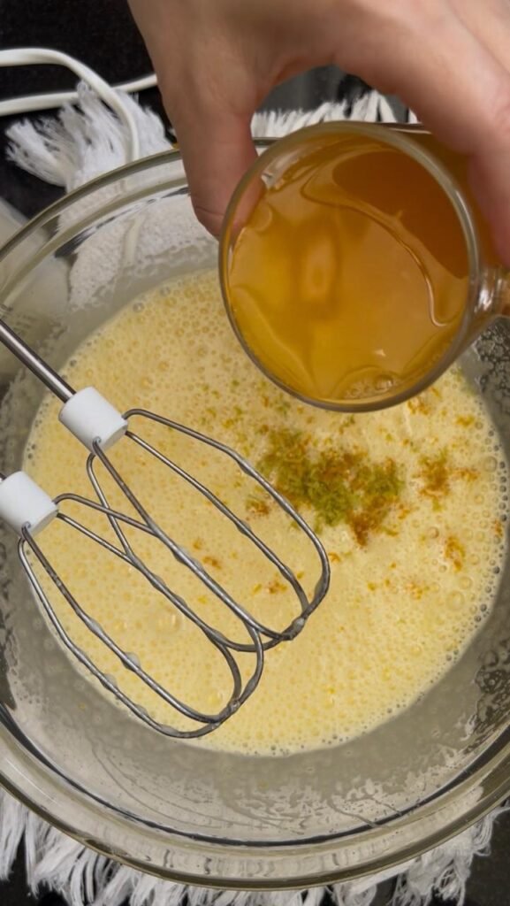 Melted butter poured into the orange almond cake batter