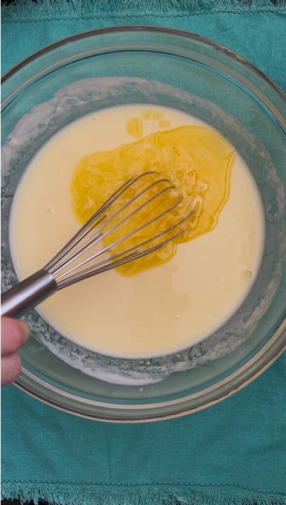 Melted butter poured into the wet pancake mixture