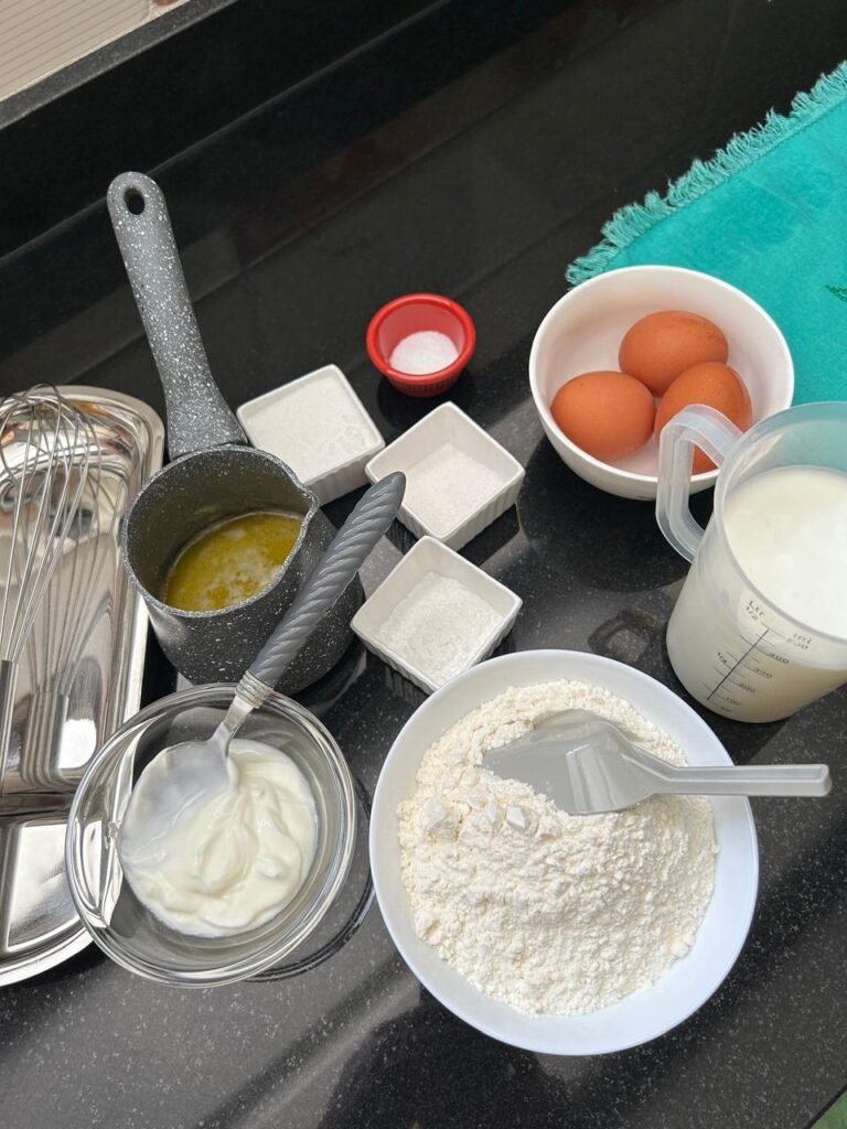 Ingredients for fluffy buttermilk pancakes: eggs, flour, buttermilk, yogurt and melted butter