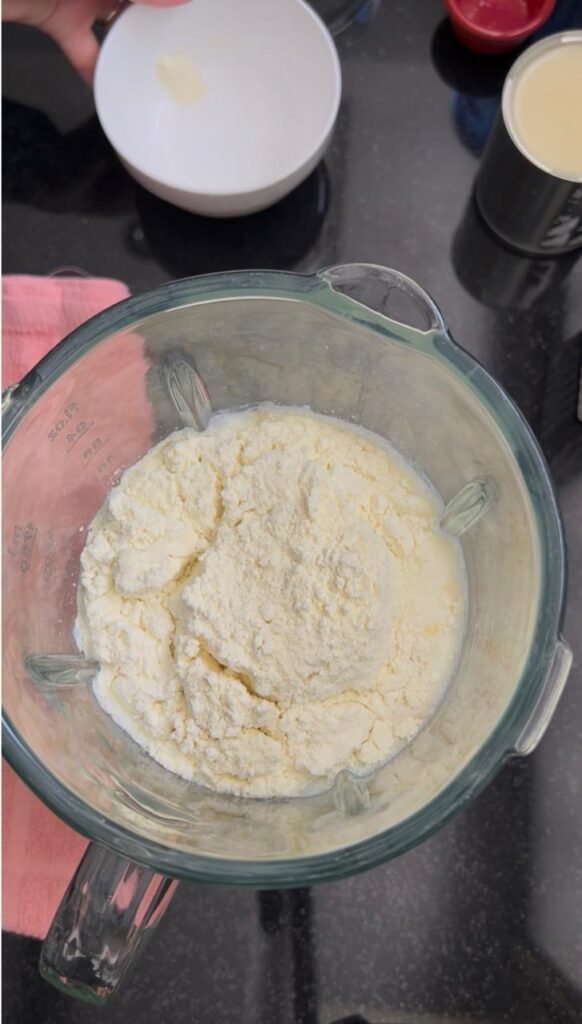 Blending eggs and powdered milk for quesillo custard