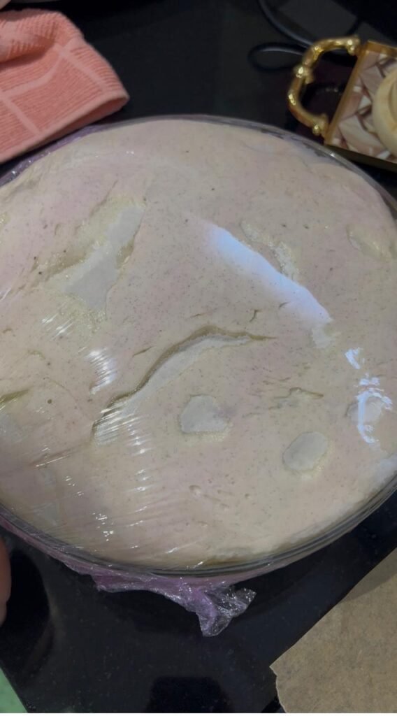 Banana roll dough doubled in volume under plastic wrap