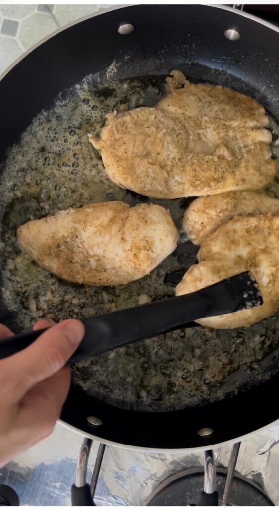 Golden seared chicken breast in the pan