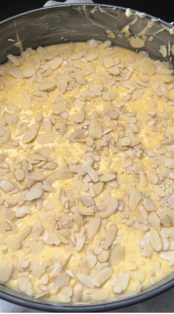 Sliced almonds scattered over the batter before baking