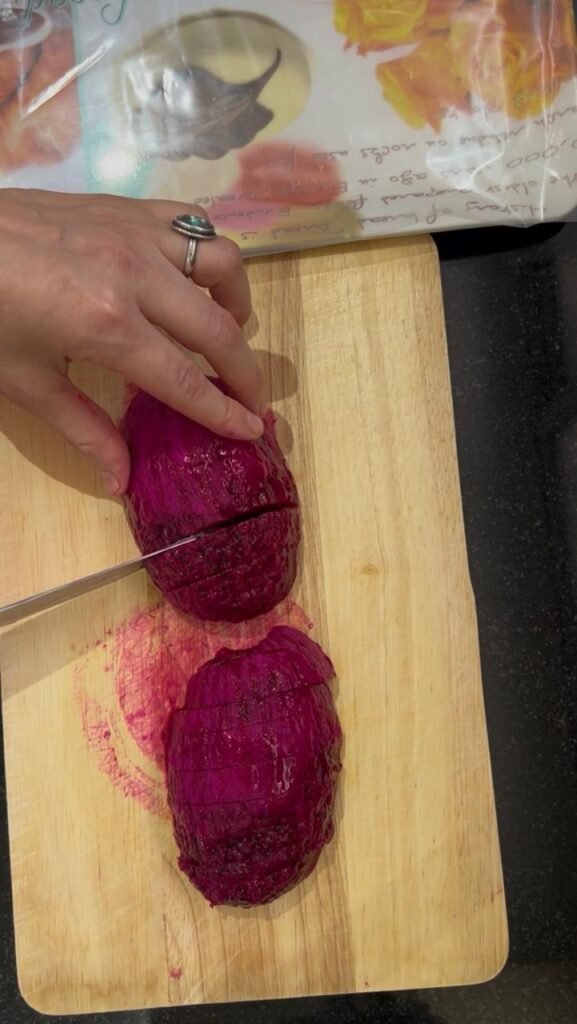 Sliced red dragon fruit on a wooden cutting board