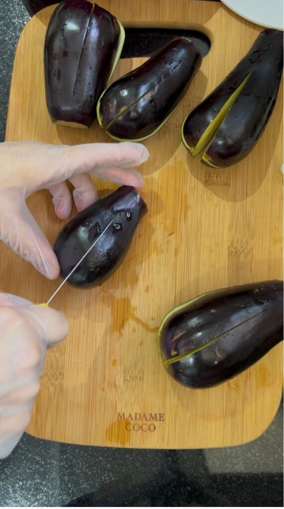 Eggplants with a lengthwise slit ready to be stuffed