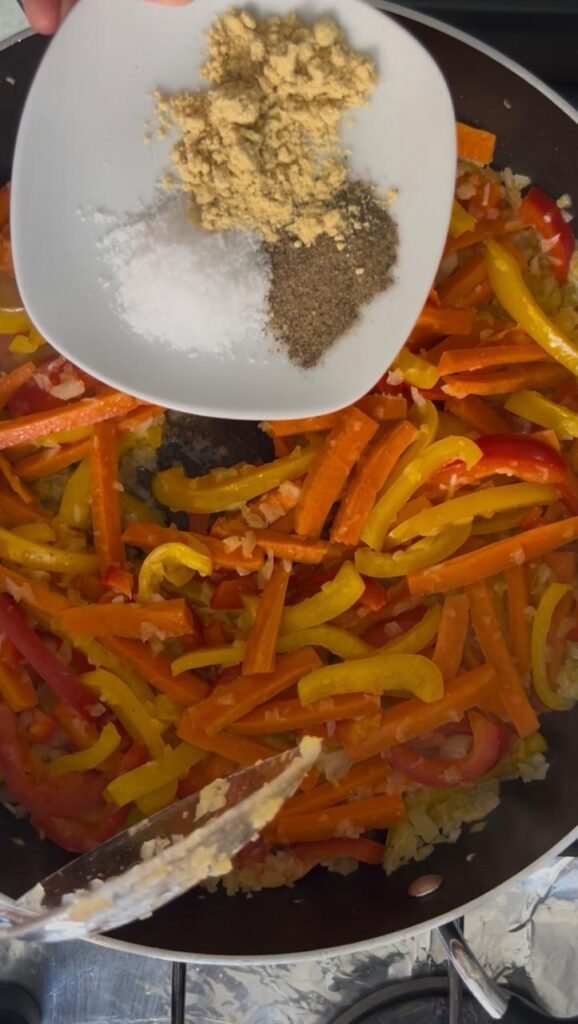 Adding salt, pepper and ginger to the stir fry vegetables