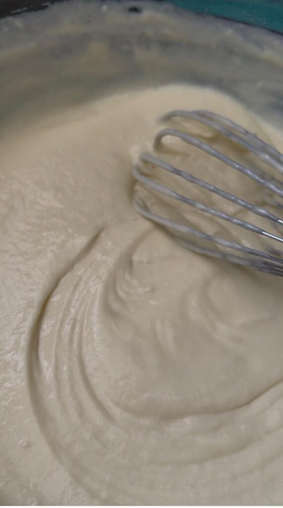 Thick fluffy pancake batter on the whisk after resting