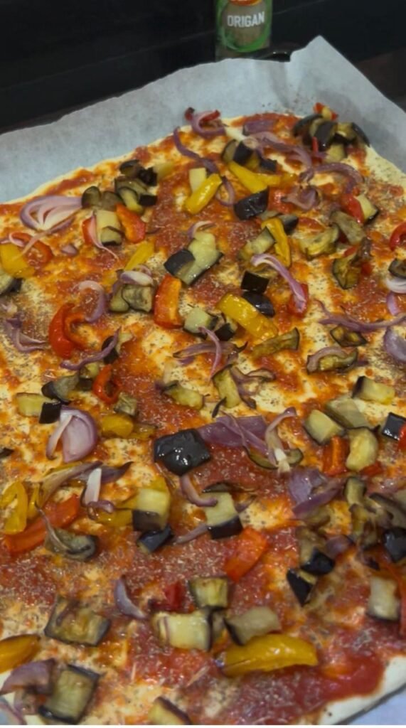 Air-fried vegetables layered over the tomato sauce