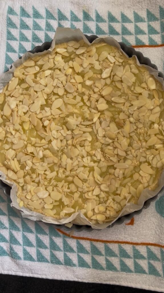 Sliced almonds scattered over the cake before baking