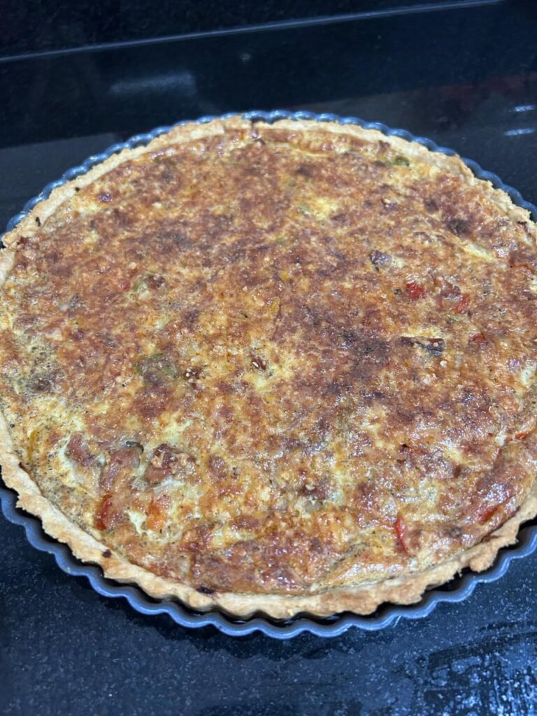 Golden baked tuna and pepper quiche in a tart pan