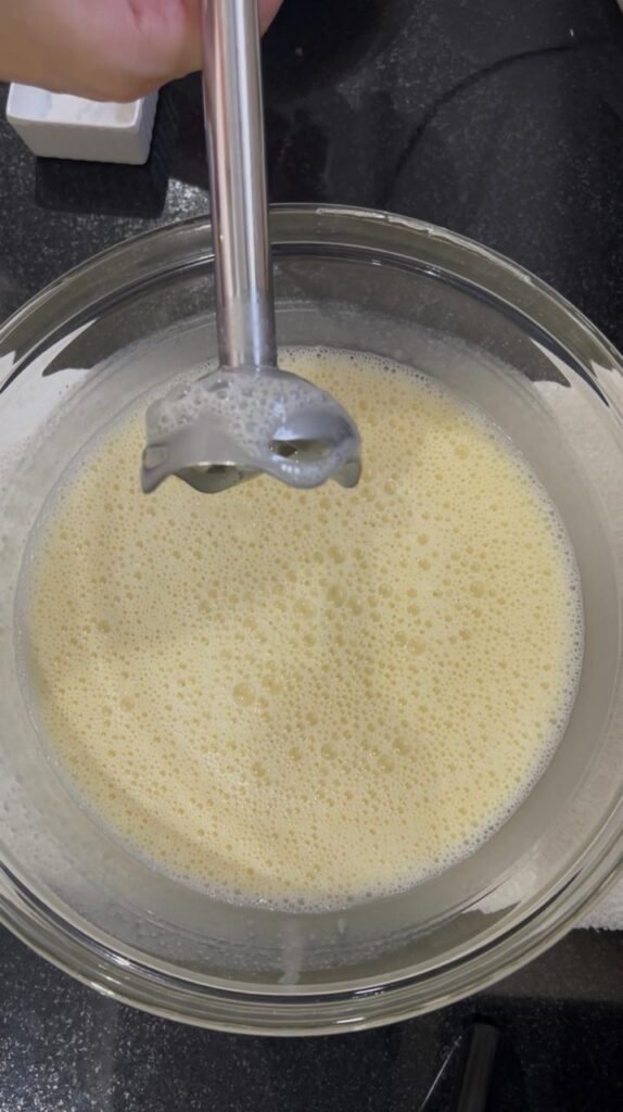 Wet ingredients blended smooth and frothy with immersion blender for banana chocolate cake