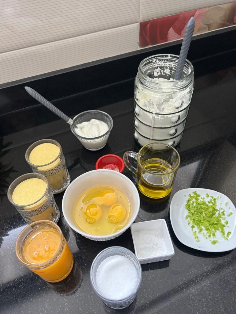 All ingredients for easy orange basbousa cake prepared and organized in small bowls and measuring cups before mixing