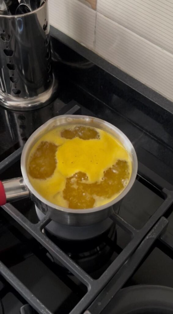Orange syrup simmering in pot for easy orange basbousa cake
