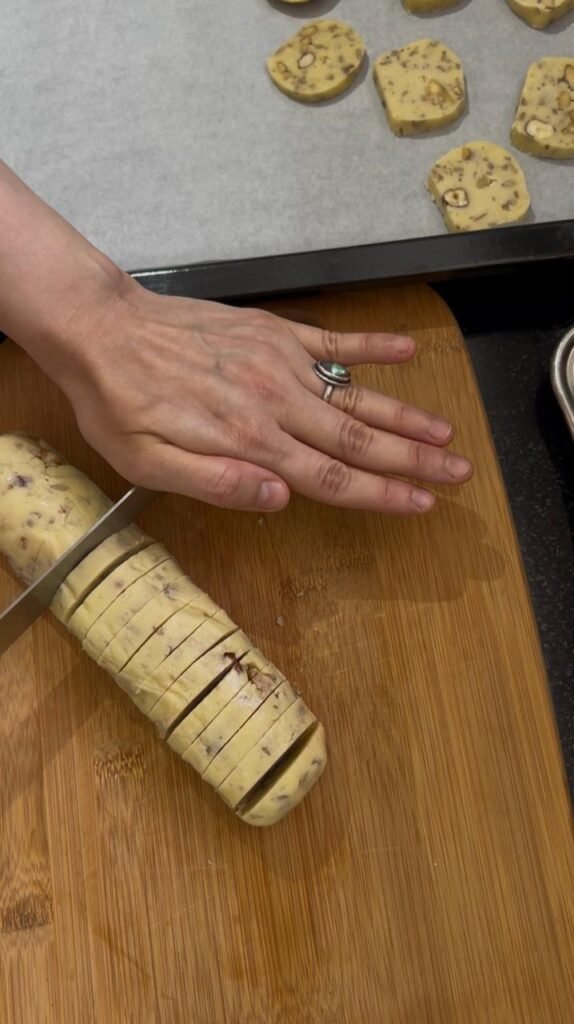 Slicing a shortbread dough log into rounds