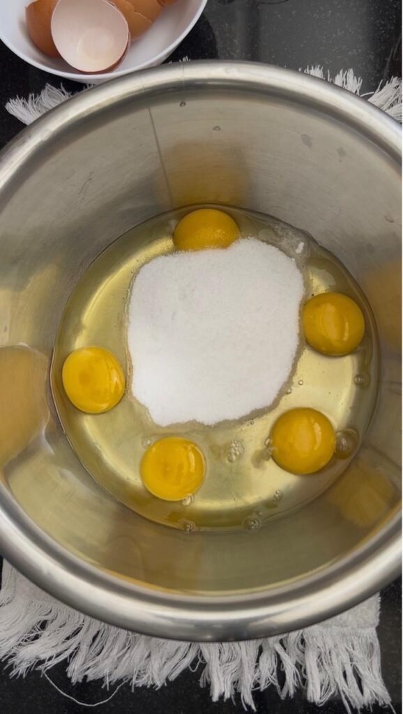 Eggs and sugar in a bowl before whisking for brownies