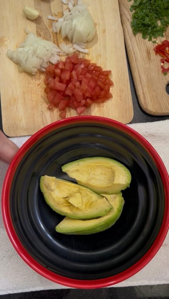 Ripe avocado halves in a bowl, ready to mash for easy homemade guacamole