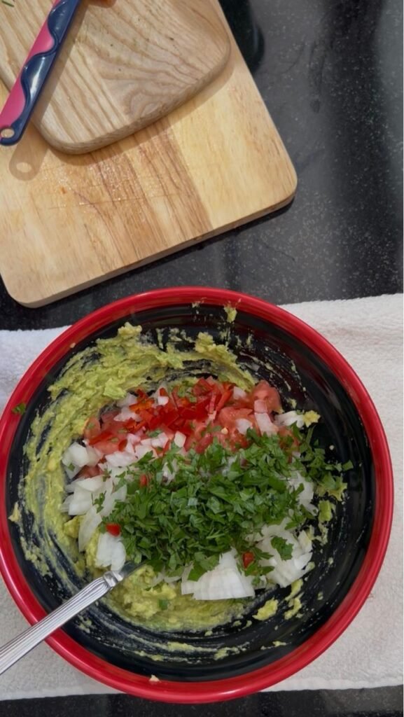 Prepped ingredients for easy homemade guacamole: diced tomato, onion, fresh parsley