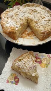 Lemon almond cake slice showing the lemon curd swirl inside
