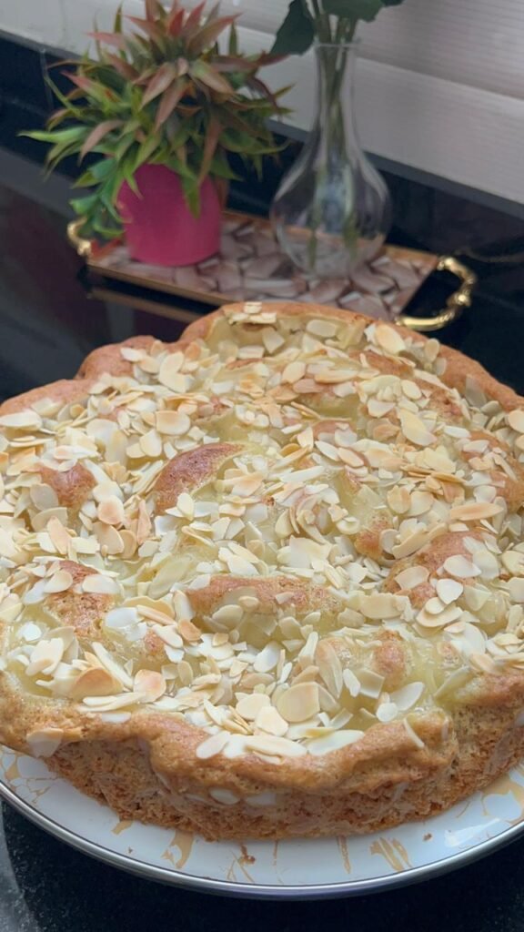 A slice of lemon almond cake on a floral plate