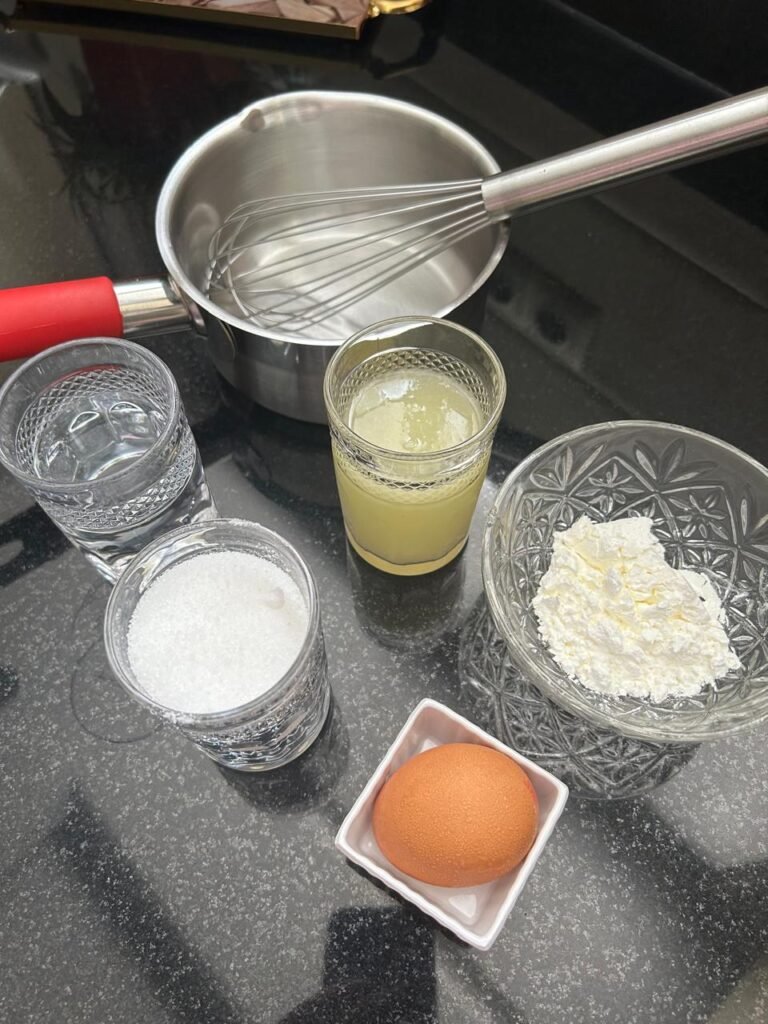 Ingredients for homemade lemon curd: lemon juice, sugar, cornstarch, and egg