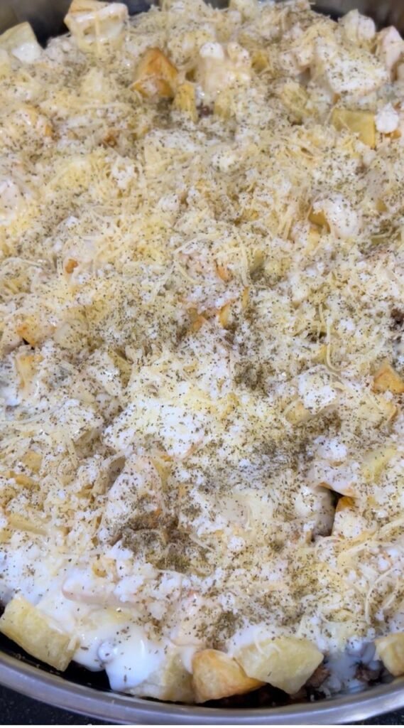 Assembled easy make-ahead moussaka showing all layers before baking