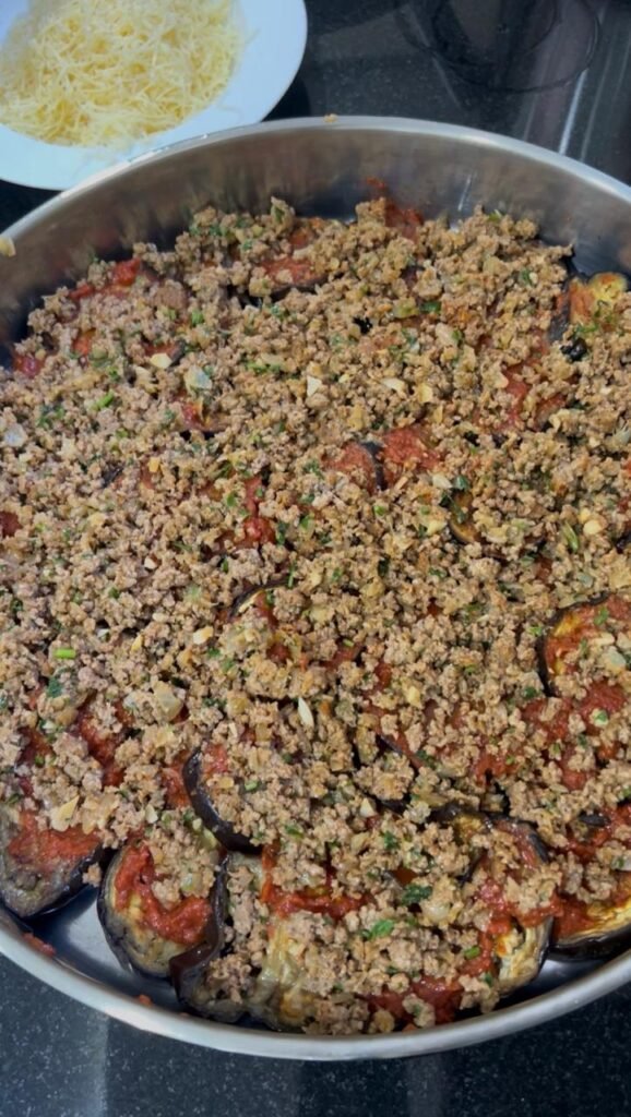 Ground beef cooking with onion, garlic, and spices for moussaka