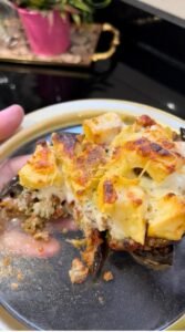 Easy make-ahead moussaka slice showing golden cheese topping and layered eggplant, meat, potato