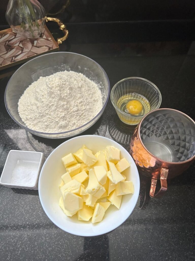Flour, cubed butter, egg and salt for a homemade quiche crust