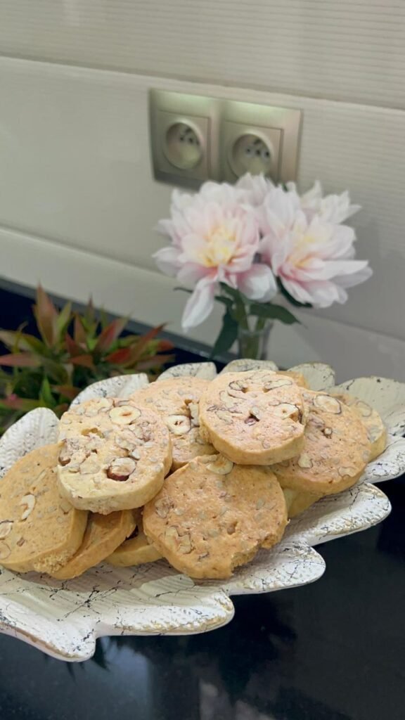 Sliced nut and seed shortbread cookie dough on parchment