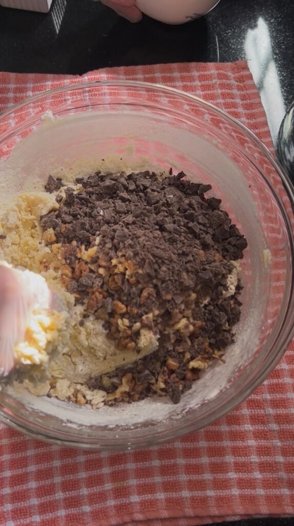 Chopped dark chocolate and toasted walnuts folded into dough for chocolate walnut sablé cookies