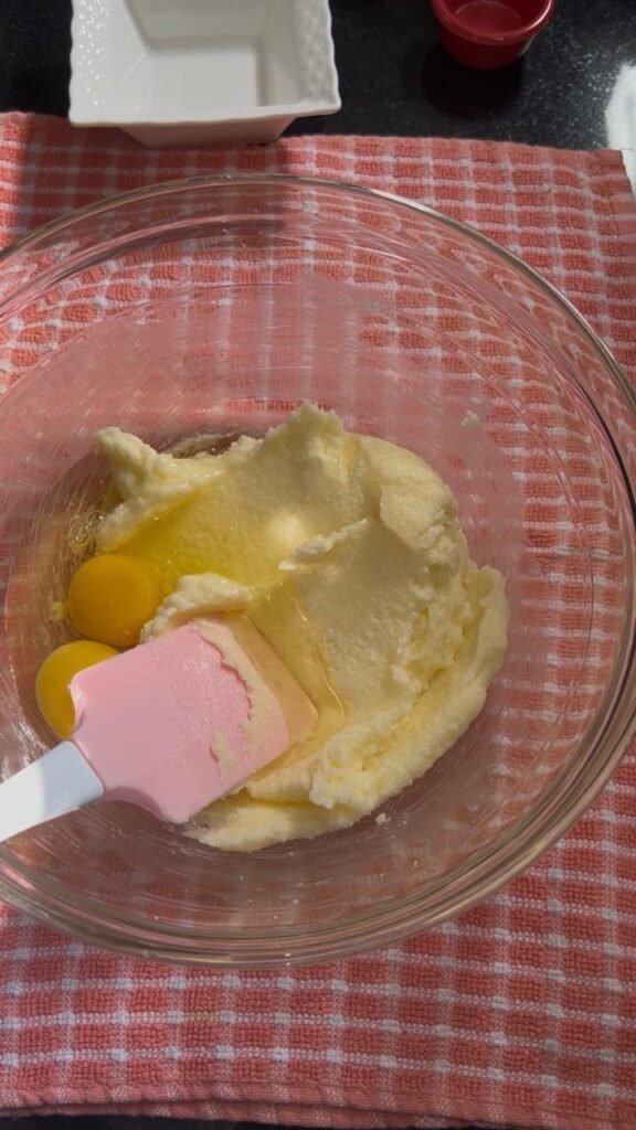 Beaten eggs mixed into creamed butter mixture for chocolate walnut sablé cookie dough