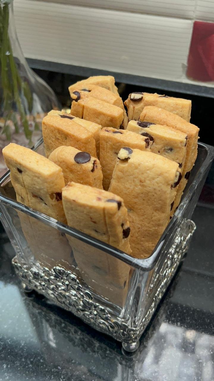 Easy chocolate chip cookie bars displayed on plate with flowers and styling for presentation