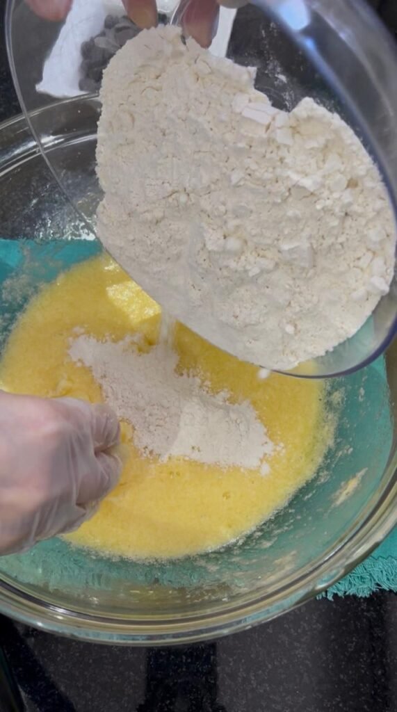 All-purpose flour and baking powder folded into easy chocolate chip cookie bars dough