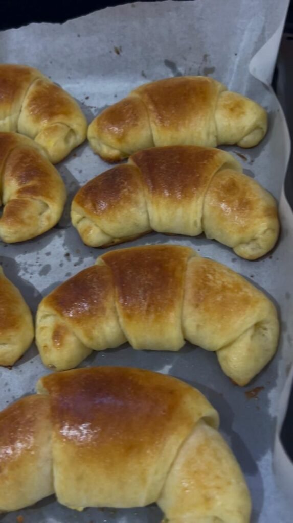 Homemade crescent rolls fresh from oven showing golden-brown exterior and fluffy texture