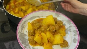Easy meatball and potato stew showing tender meatballs, potatoes in golden sauce